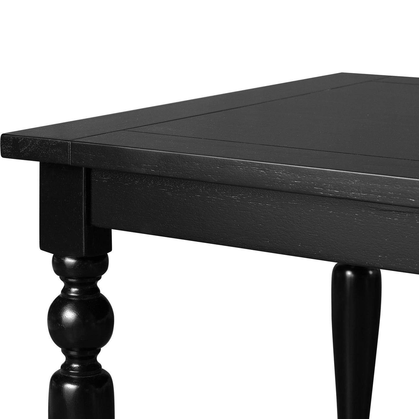 Close-up of a black rectangular dining table showing turned legs and sleek tabletop edge detail. Ideal for modern or farmhouse dining room settings