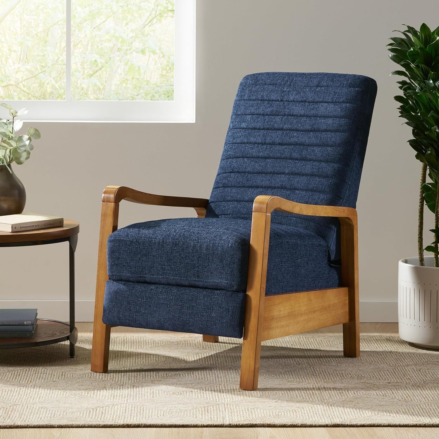 A stylish mid-century modern recliner chair with a navy blue fabric upholstery and light wood arms, perfect for a living room or reading nook.